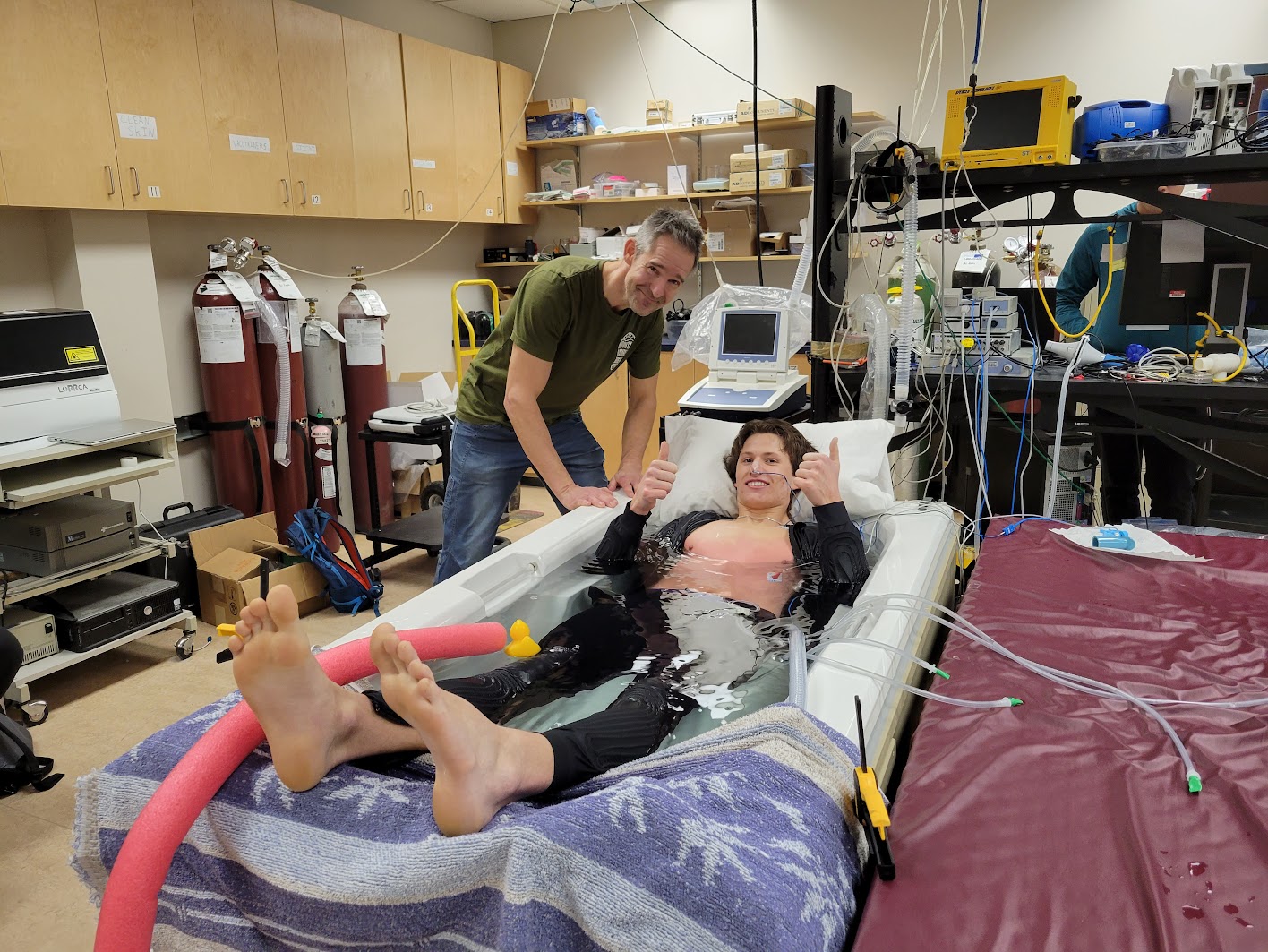 Dr. Phil Ainslie watches on as undergraduate student Justin Monteleone completes a hypothermia protocol. This involved laying submerged for up to an hour in seven-degree Celsius water.