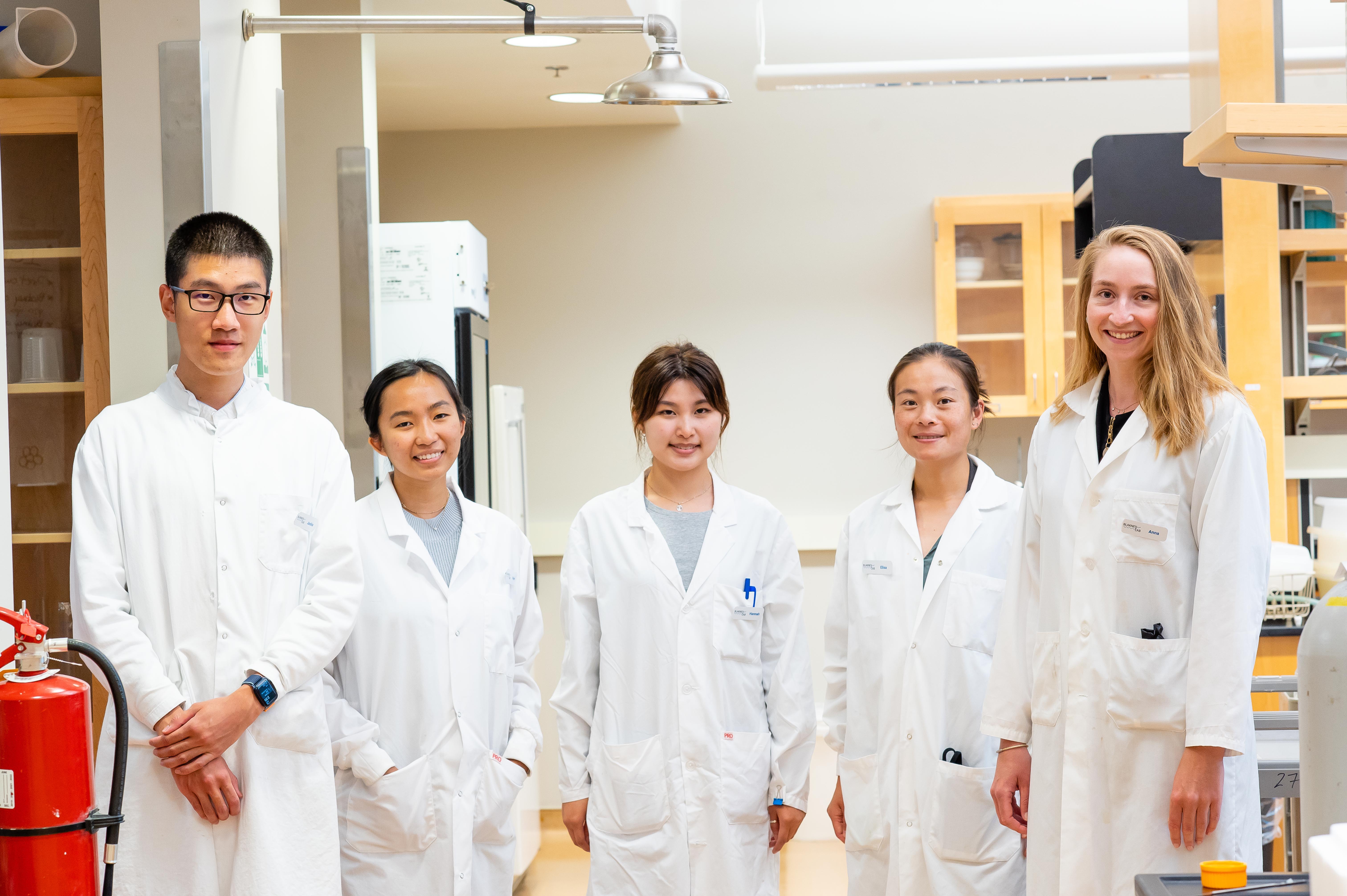 Photo of Dr. Anna Blakney (far right) with her research team at UBC. 