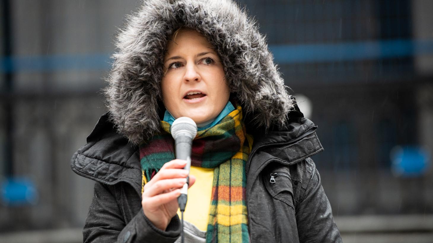 Photo of Lauryn Oates speaking into a microphone.