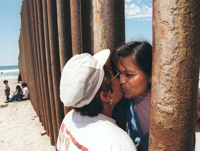 BETWEEN BORDERS: When one in every 110 people on Earth has been forced to flee, some nations respond with barriers, like “the wall” between the United States and Mexico. Photo: Getty Images, Hector Mata