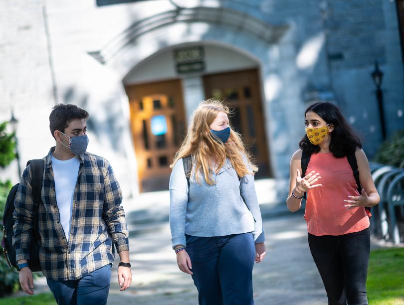 Three students walking outside on UBC Vancouver campus.