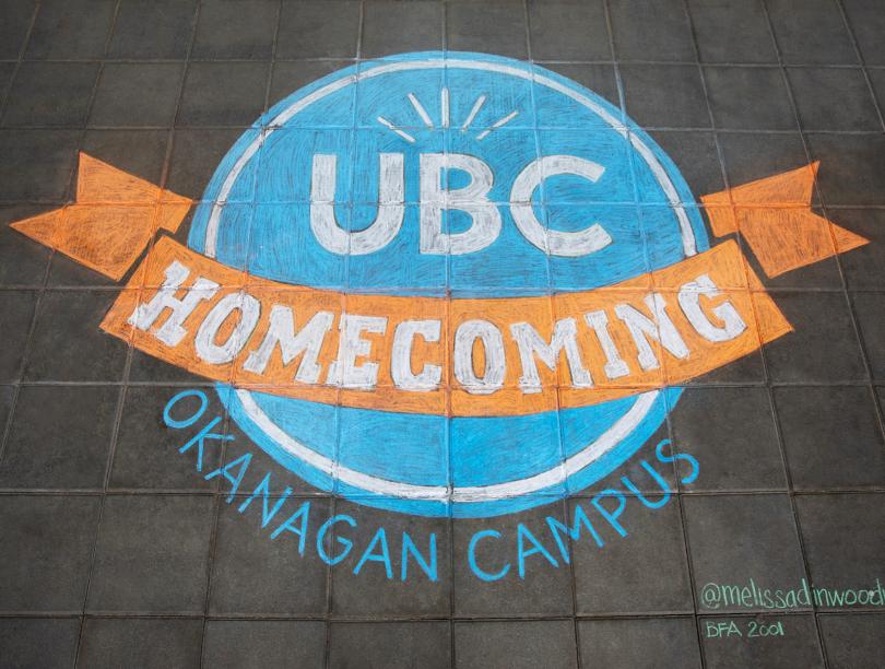 Overhead shot of a chalk rendering of the UBC Homecoming Okanagan Campus logo