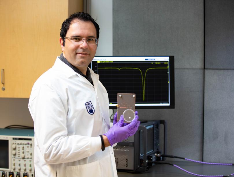 Photo of Mohammad Zarifi posing with his sensor invention. 