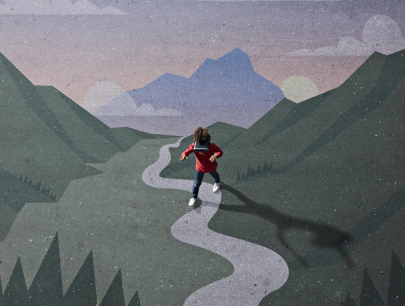 Boy wearing VR headset while walking across illustration of mountains and valley