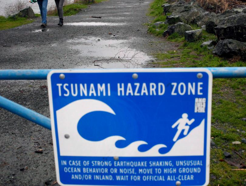 Blue sign on gate states "Tsunami hazard zone"