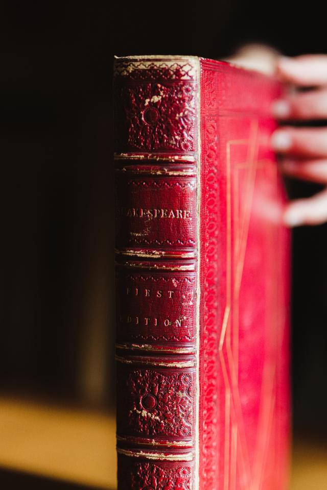 Red book cover of William Shakespeare's First Folio, angled to show the spine
