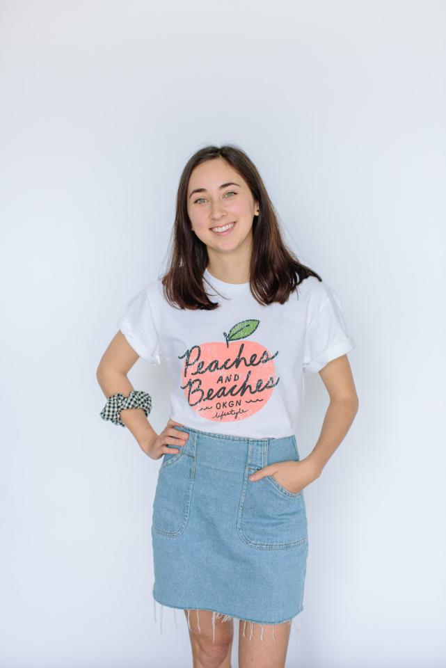 Ashleigh Green wearing a T-shirt with an illustration of peaches that she created