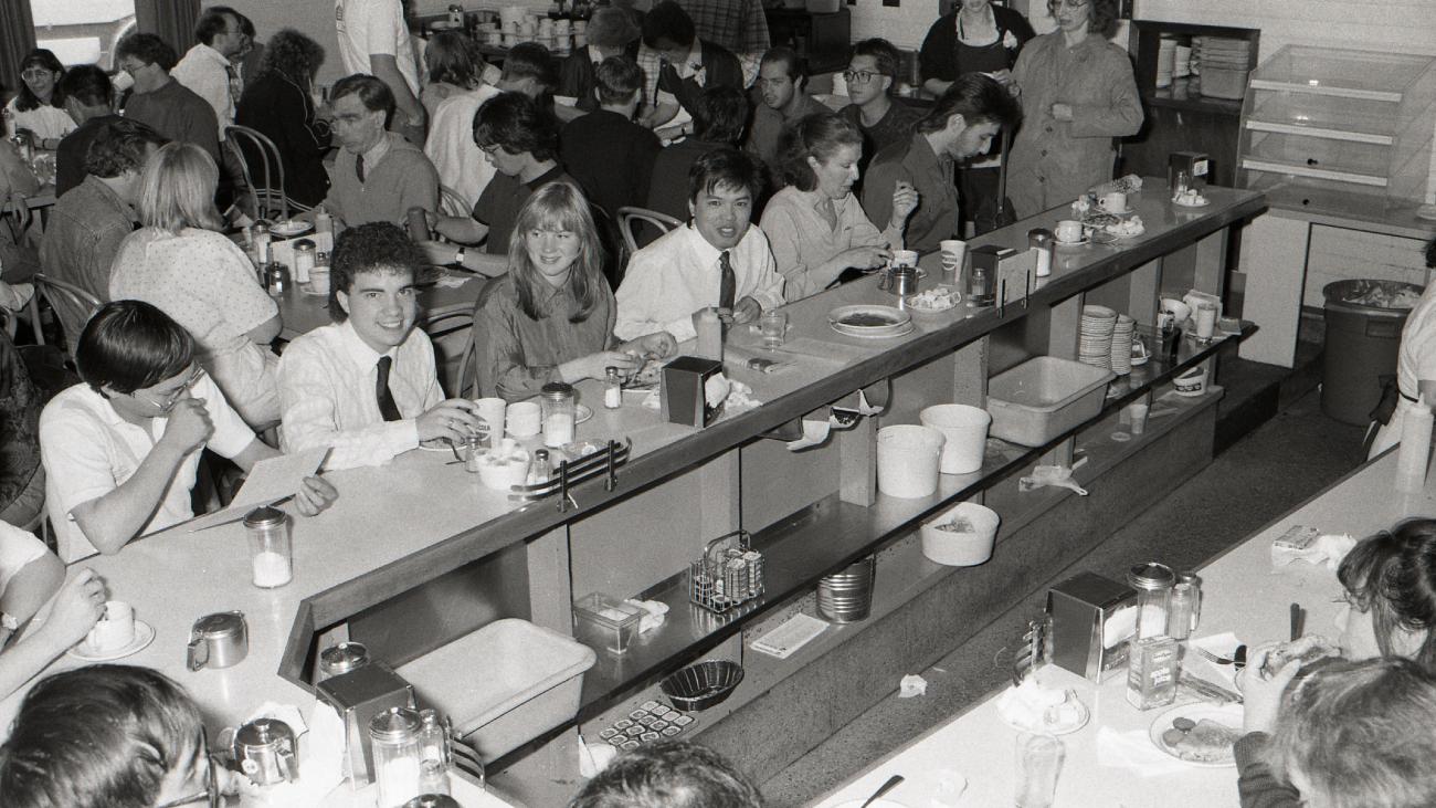 Black and white photo of UBC students in a cafeteria.
