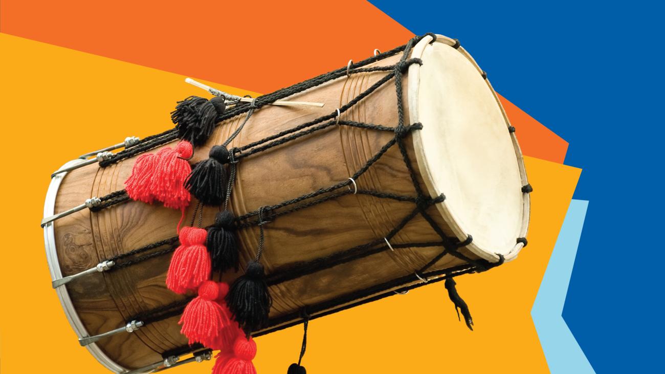 Photo of a drum against a yellow, orange and blue background.