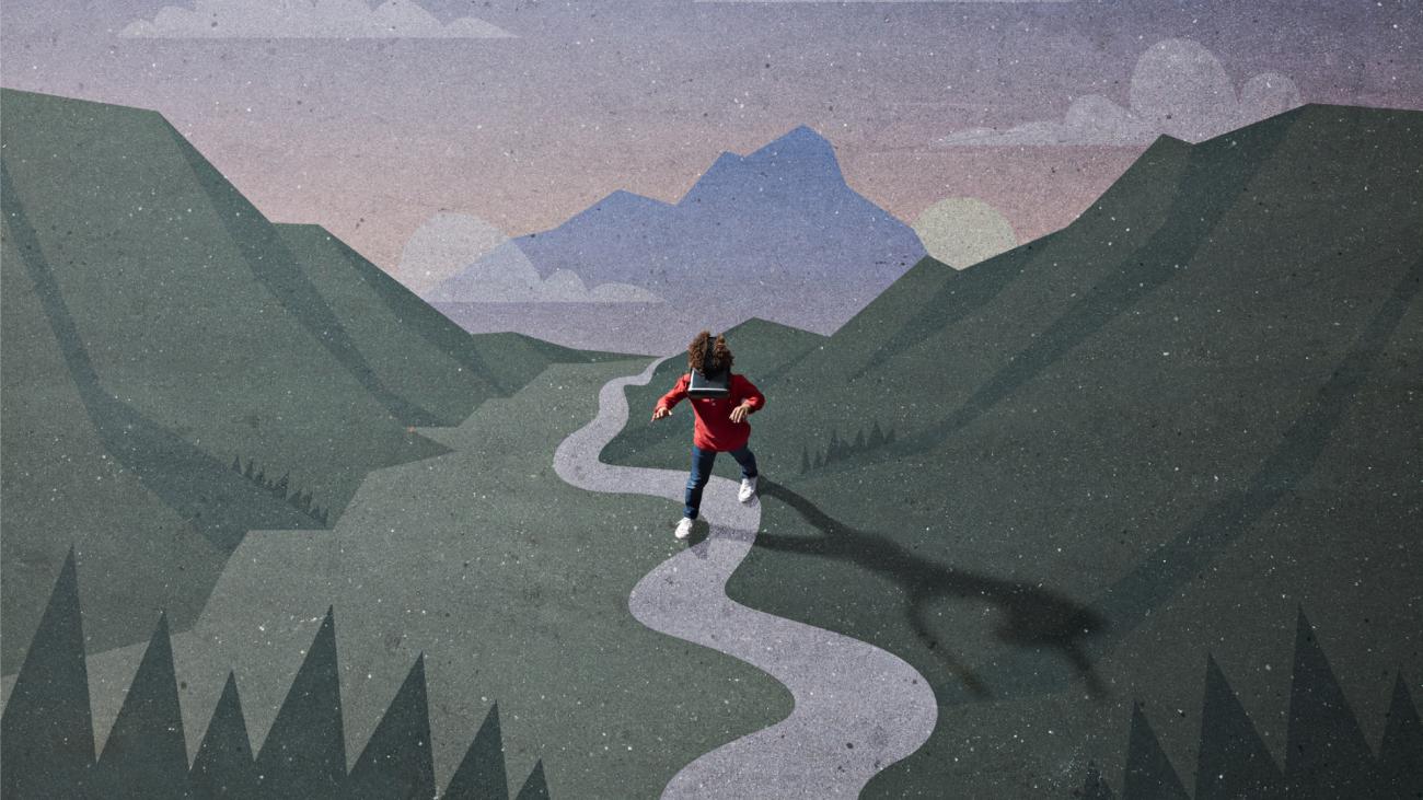 Boy wearing VR headset while walking across illustration of mountains and valley
