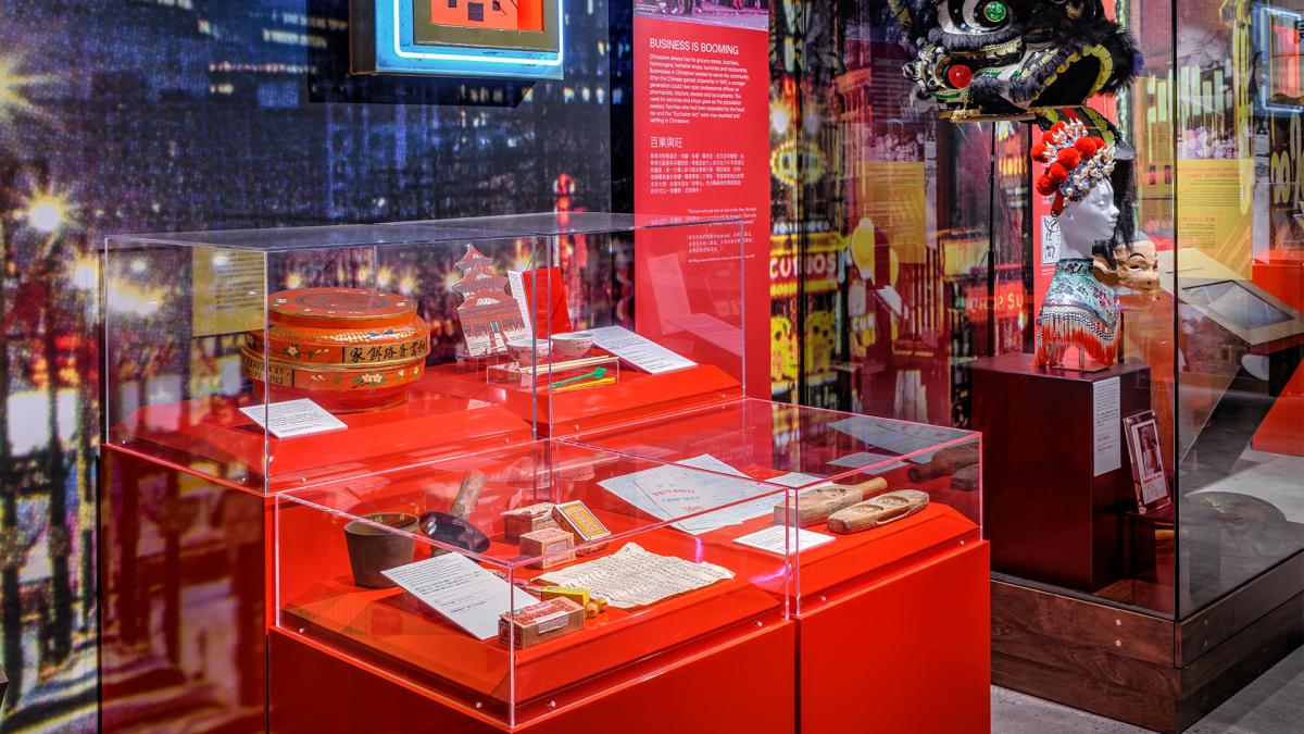 A display case with colourful artifacts, on a vibrant red surface