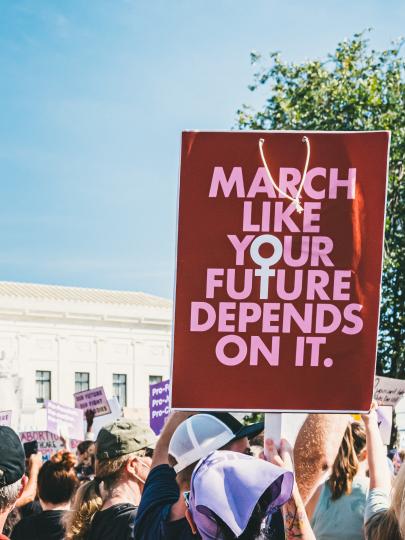 Crowd outside the U.S. Supreme Court, protesting the possible overturning of Roe v. Wade. One prominent sign reads: "March like your future depends on it."